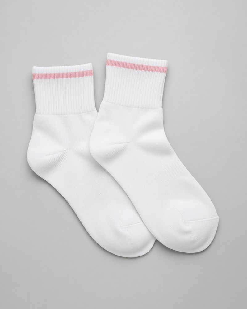 A pair of white running socks with a pale pink cuff