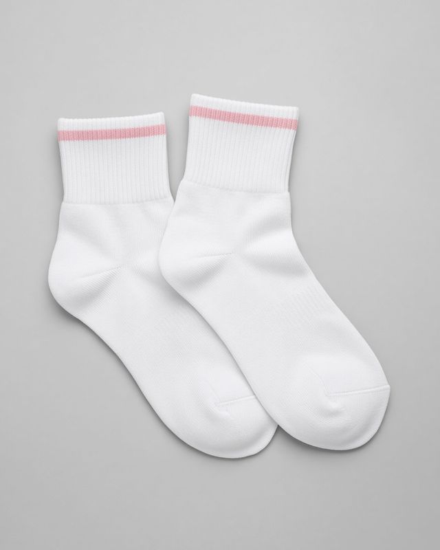 A pair of white running socks with a pale pink cuff